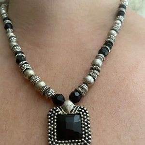 Costume jewelry with black and silver beads.